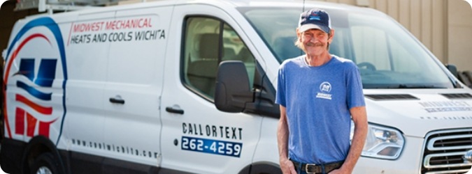 Midwest Mechanical employee standing in front of a company van