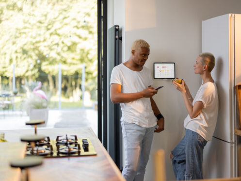 Girl choosing temperature on smart home thermostat