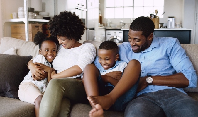 Family relaxing on couch in their family room